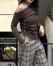 Asymmetrical gold button tops