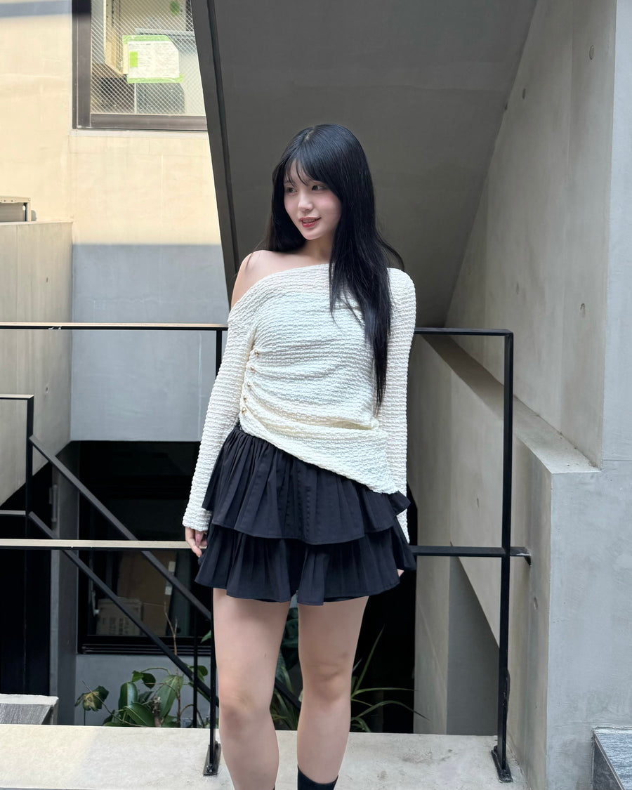 Asymmetrical gold button tops