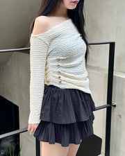 Asymmetrical gold button tops