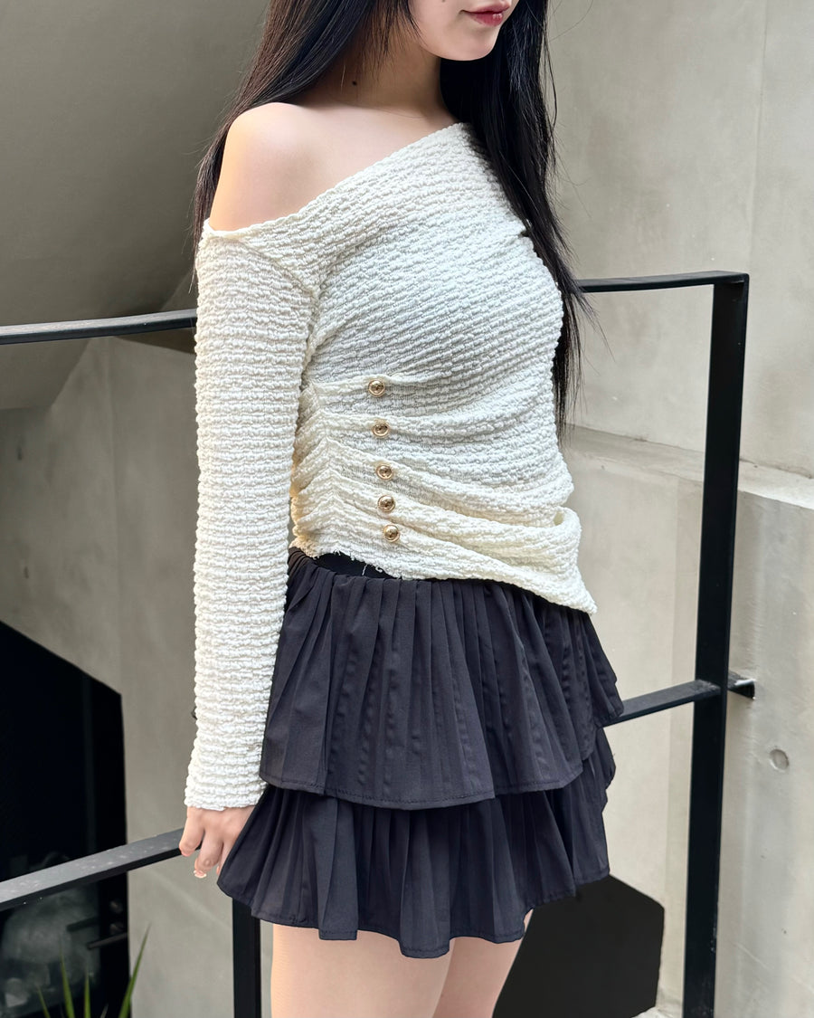 Asymmetrical gold button tops