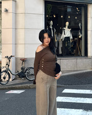 Asymmetrical gold button tops