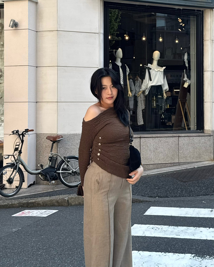 Asymmetrical gold button tops