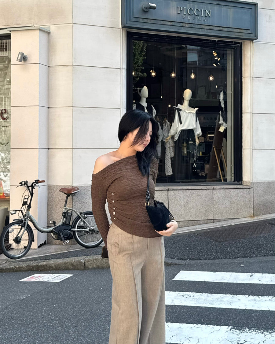 Asymmetrical gold button tops